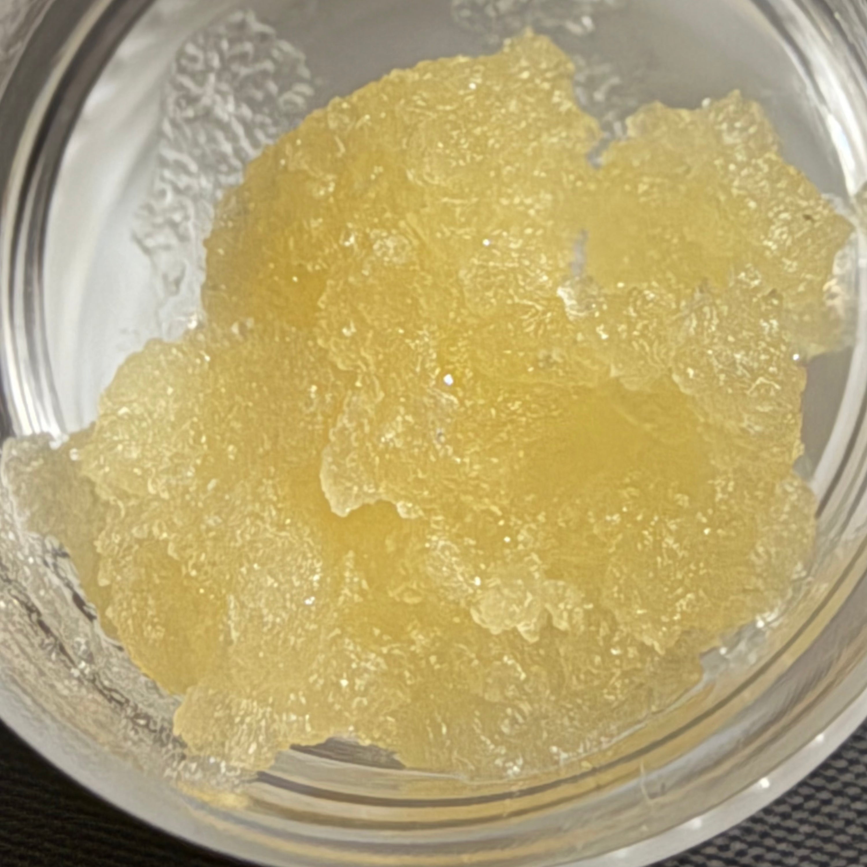 Golden Gardens 1g Live Resin Sugar in a clear container with a textured lid.