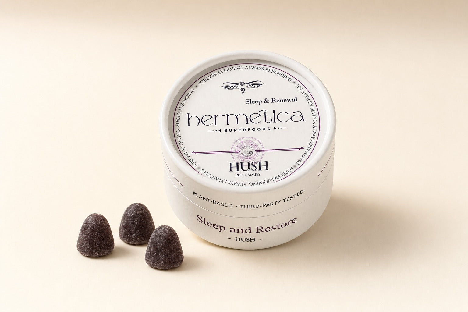 Hermetica HUSH organic sleep gummies in a cream 20-count tin with three dark plum gummies